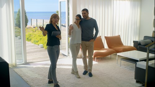 Couple and estate agent viewing a house