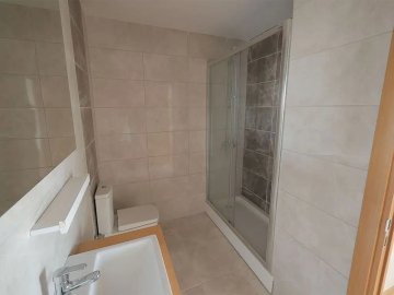 large-fully-tiled-bathroom-with-shower