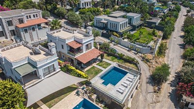 Luxurious unique villa in Gumusluk For Sale – Arial view to the side of villa