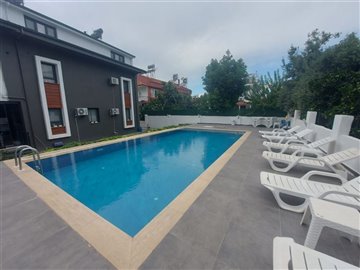 Great location Fethiye Apartment For Sale - Communal swimming pool with sun terrace