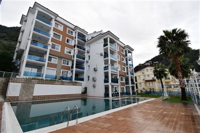 Spacious Fethiye Four Bedroom Duplex Apartment For Sale In A Popular Residential Location- Main view of apartment block and pool