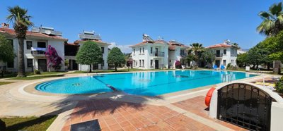 Delightful Garden Floor Apartment In Fethiye For Sale - Sunbathing spots all around the pool