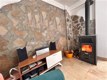 Detached Sea View Villa in Akbuk For Sale- Feature stone wall and modern wood burning stove