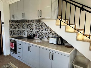 Idyllic Fully Furnished Duplex Apartment For Sale - Modern kitchen tucked under the stairs