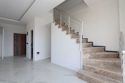 Sea View Duplex Apartment For Sale in Mahmutlar, Alanya - Front door and open-plan living space with staircase