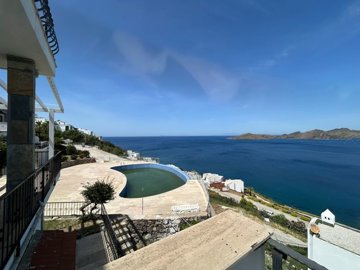 A Must-See Duplex Apartment For Sale In Bodrum - Views down to the shared pool and magnificent sea and mountains