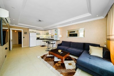 A Chic Sea View Apartment For Sale in Mahmutlar, Alanya - Large living space with open-plan kitchen
