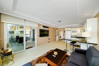 A Chic Sea View Apartment For Sale in Mahmutlar, Alanya - View from the lounge area to the kitchen and balcony 