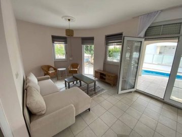 A beautiful Detached Golf Villa in Antalya For Sale - Lounge area with access to the pool and covered terrace