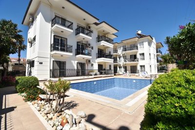 Must-See Garden Floor Apartment In Fethiye For Sale - Main view of apartment and shared pool