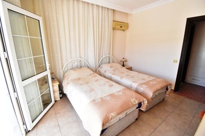 Must-See Garden Floor Apartment In Fethiye For Sale - Second double bedroom furnished with twin beds