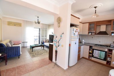 Must-See Garden Floor Apartment In Fethiye For Sale - Open-plan kitchen through to the lounge