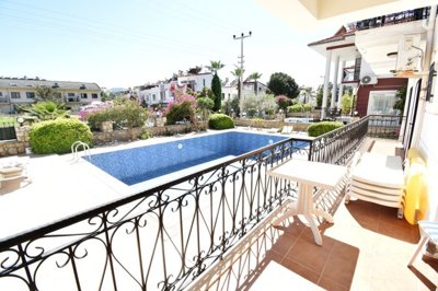 Must-See Garden Floor Apartment In Fethiye For Sale - Sun-drenched balcony overlooking the pool