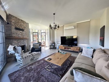 Charming Golf Villa In Bodrum For Sale - A large comfortable lounge with a fireplace
