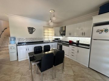 A charming Dalyan Private Villa For Sale With Pool - A modern kitchen with all white goods