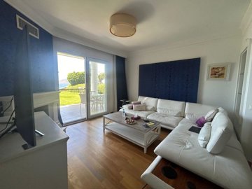 Divine Sea View Bodrum Garden Apartment In Gumusluk For Sale – Modern furnished lounge with garden and terrace access