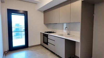 City-View Apartments For Sale In Kusadasi - Modern kitchen with balcony access
