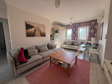 Beautifully Maintained 1-Bed Apartment For Sale In Gulpinar, Dalyan - Modern lounge through to the renovated kitchen