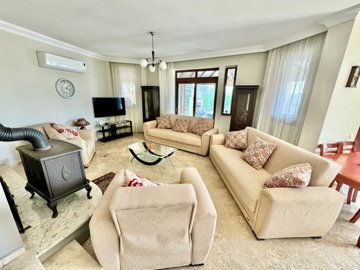 A Detached Villa For Sale In Seydikemer, Fethiye - Lounge area with modern furnishings and a log burner