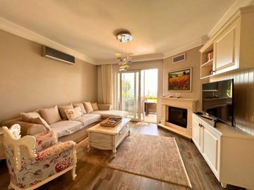 Idyllic Sea View Apartment In Gumusluk, Bodrum For Sale – Lounge with fireplace and garden access