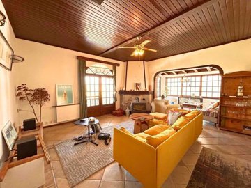 Charming Sea-View Yalikavak Triplex Villa For Sale – Lounge with stone fireplace