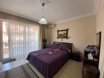 A Must-See & Ready-To-Move Apartment For Sale In Didim – Master bedroom with shared balcony & ensuite