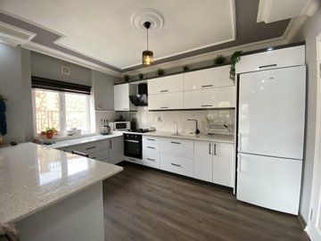 A Beautifully Renovated Apartment For Sale In Didim - Brand new kitchen with breakfast bar