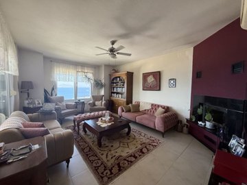 Sea And Sunset View Reverse Duplex In Bodrum For Sale - Spacious lounge with sea views and fireplace