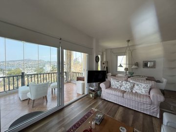 A Sea & Nature View Apartment In Bodrum For Sale - Lounge and enclosed balcony