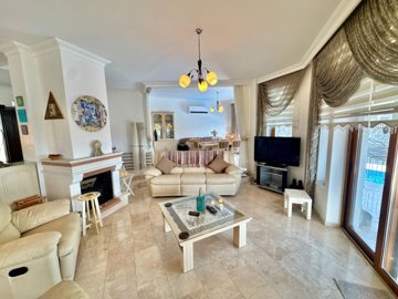 Ornate Detached Villa In Fethiye For Sale - Lounge with fireplace to the dining area