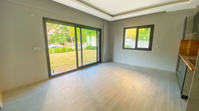Modern Kusadasi Garden Apartments For Sale - Living space with garden access