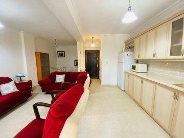 Garden Apartment In A Great Location For Sale In Altinkum – Open-plan lounge and kitchen