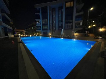 Immaculate Apartment In Kusadasi For Sale With A Shared Pool - Evening views of the pool and terraces