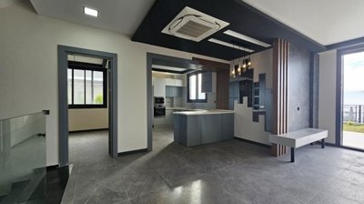 State Of The Art Villa In Kusadasi For Sale With Sea Views Near The Beach - Lounge to the kitchen