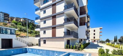 Newly Built Apartments In Kusadasi With A Shared Pool For Sale - A modern apartment complex