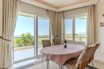 Blissful 2-Bedroom Apartment For Sale In Alanya, Mahmutlar – Dining area to the balcony