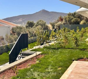 Desirable Kalkan Apartment For Sale - Garden outside the apartment with mountain views