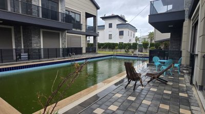 Tasteful Belek Apartment In Antalya For Sale - Communal swimming pool and sunbathing terrace