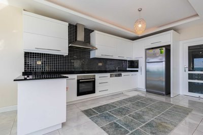 Immaculate Alanya Apartment In Kestel For Sale - Kitchen with built-in white goods