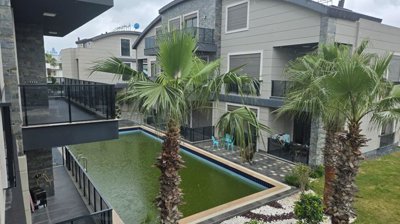 Outstanding Belek Apartment For Sale In Antalya - A beautiful complex with a pool and garden