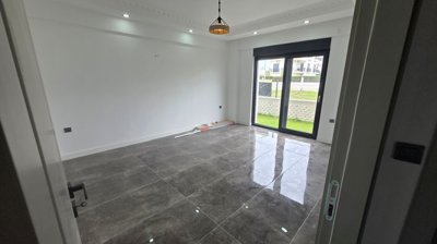 Brand-New Villa For Sale in Belek, Antalya With A Private Pool - First bedroom with garden access