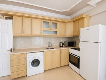 Great Value Apartment For Sale In Altinkum – Kitchen with white goods and appliances