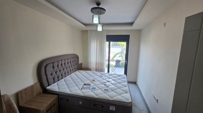 Furnished Garden-Floor Apartment In Belek For Sale With A Shared Pool - Great-sized double bedroom with garden access