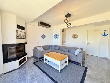 Exquisite Semi-Detached Yalikavak Villa For Sale - Lounge with a modern fireplace