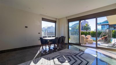Superior Villa For Sale in Belek, Antalya With A Private Pool & Facilities - Dining area with pool and garden views