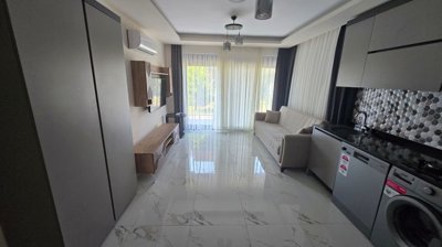 Belek Apartment With A Private Garden For Sale - Kitchen and lounge