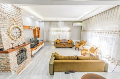Incredible Antalya Property For Sale - Large lounge with a modern fireplace