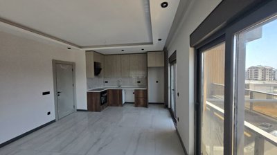 Residential Antalya Apartments In Altintas For Sale - Open-plan living room and kitchen
