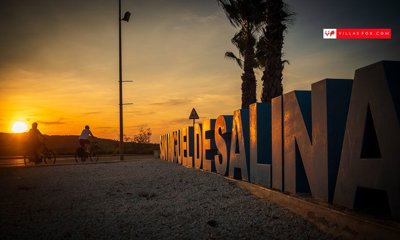 1591001sanmigueldesalinascyclistsandtownsigna