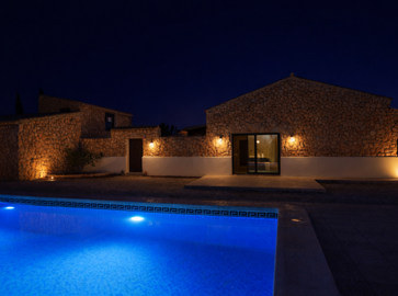 rustic-villa-and-glowing-pool-at-night-758x56